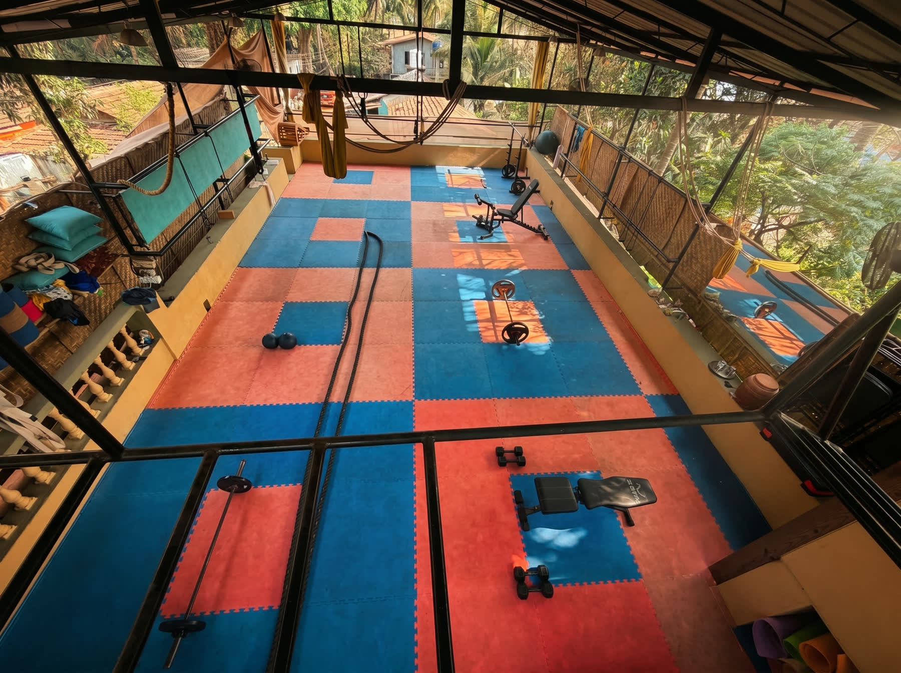 overhead view of the open-air training floor with battle ropes and weights