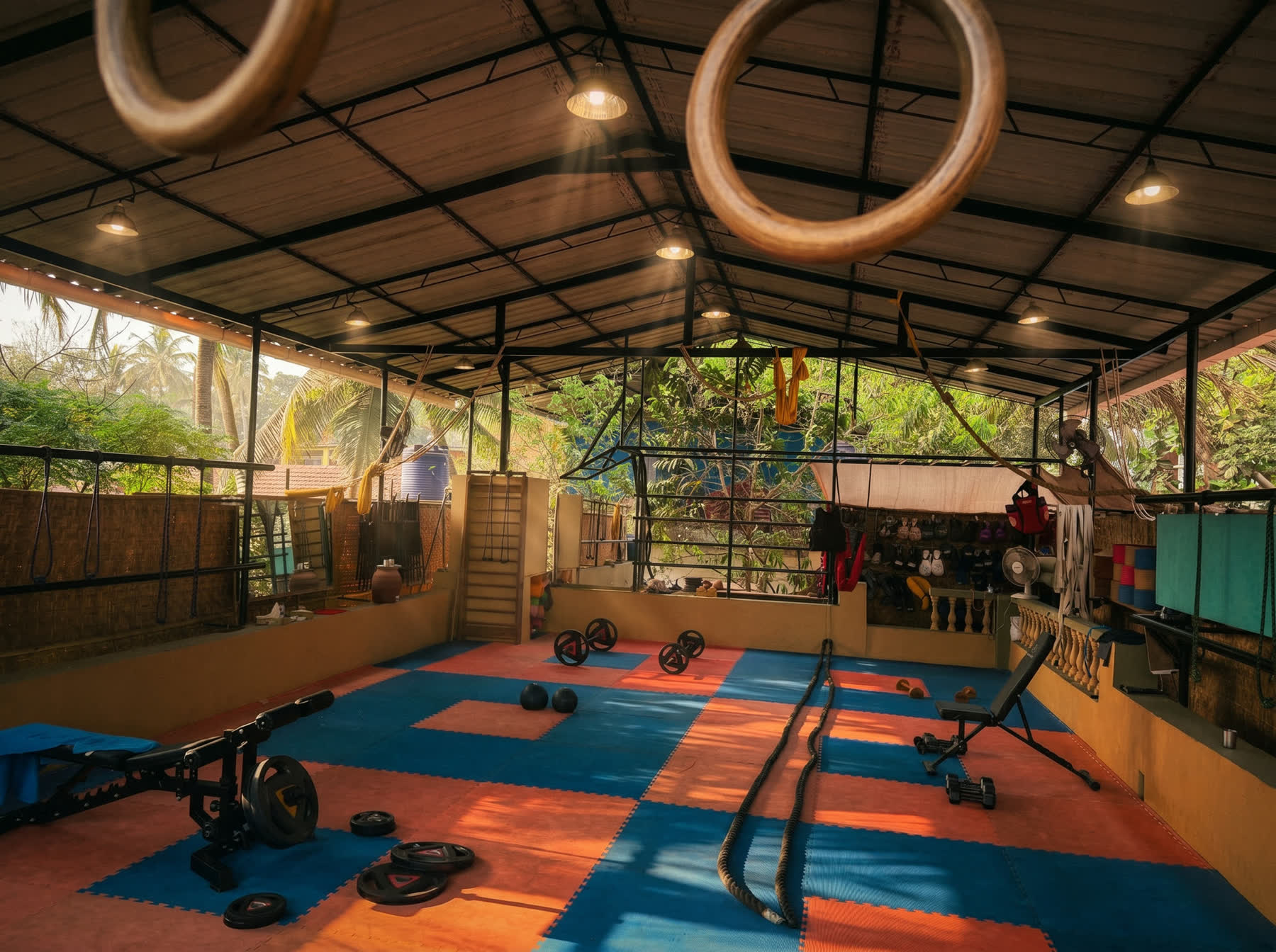 gymnastic rings, weights and bench at the open air gym in assagao